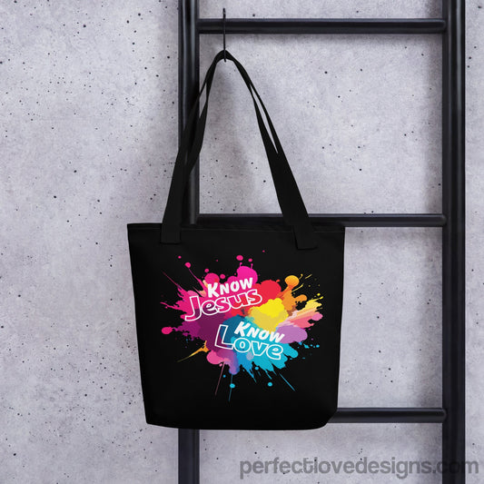 Black tote bag hanging on hook with faith-based message "Know Jesus Know Love"